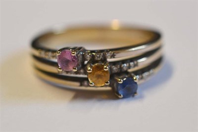 Lot 1141 - A Contemporary Sapphire and Diamond Ring, the ring of three bands, each set with a different...