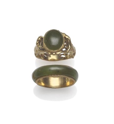 Lot 1146 - A Jade Band Ring, the jade modelled in a D shaped band form, with a gold inner shank with...