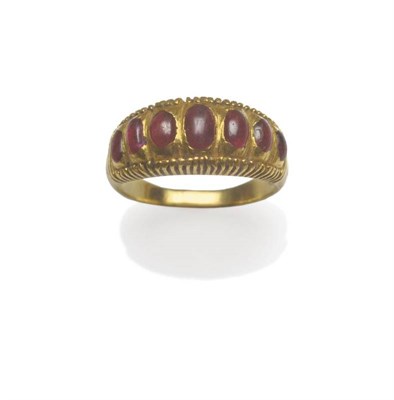 Lot 1151 - A Ruby Half Hoop Ring, with seven graduated cabochon stones in yellow rubbed over settings, to...