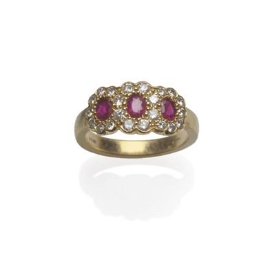 Lot 1152 - An 18 Carat Gold Ruby and Diamond Triple Cluster Ring, three oval mixed cut rubies within...