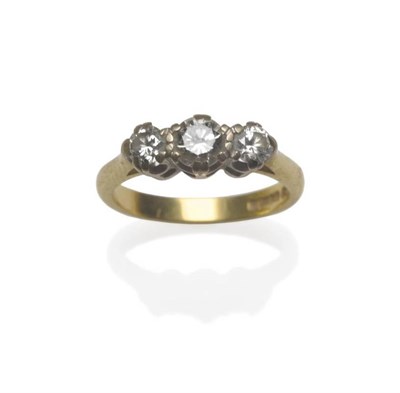 Lot 1156 - An 18 Carat Gold Diamond Three Stone Ring, the round brilliant cut diamonds in white claw settings