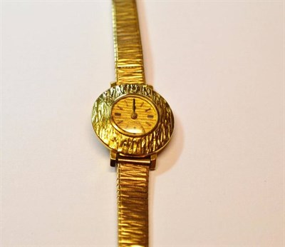 Lot 1160 - A Lady's 18ct Gold Wristwatch, signed Omega, circa 1970, lever movement, bark finished dial...