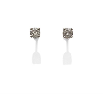 Lot 1164 - A Pair of Diamond Solitaire Stud Earrings, the round brilliant cut diamonds in yellow four claw...