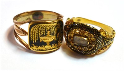 Lot 1175 - Two Mourning Rings, the first with a curved oblong panel enamelled in black to depict an urn...