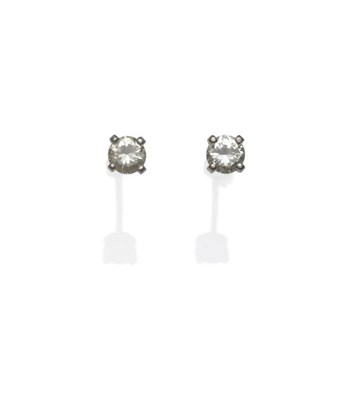 Lot 1180 - A Pair of Diamond Solitaire Earrings, the round brilliant cut diamonds in white four claw settings