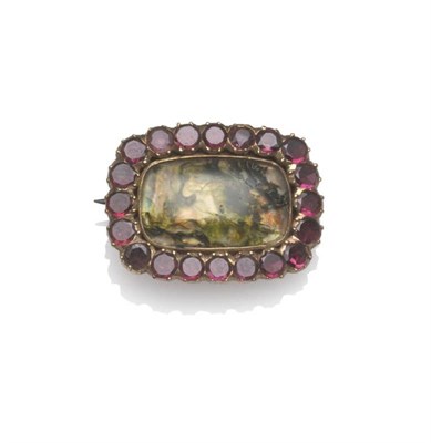 Lot 1197 - A Georgian Moss Agate and Garnet Brooch, the oblong cabochon agate within a border of round cut...