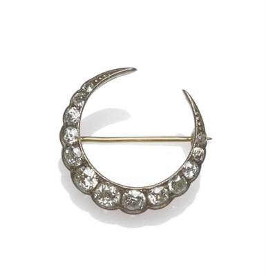 Lot 1199 - A Late Victorian Diamond Crescent Brooch, set with graduated old cut diamonds in white claw...