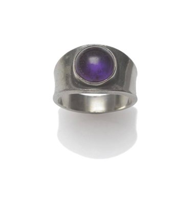 Lot 1216 - A Ring, by Georg Jensen, a round purple cabochon stone within a tapered mount, model number...