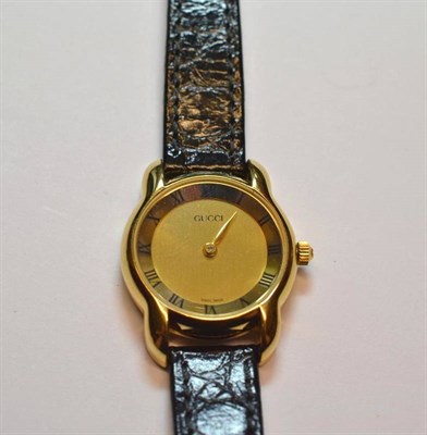 Lot 1225 - A Lady's Wristwatch, signed Gucci, circa 1997, quartz movement, gilt dial with Roman numeral...