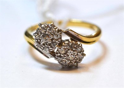 Lot 1229 - A Diamond Double Cluster Ring, the old cut diamonds in white claw settings, on a twist...