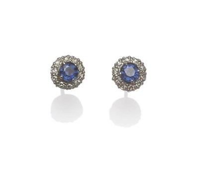 Lot 1234 - A Pair of Sapphire and Diamond Cluster Stud Earrings, a round mixed cut sapphire within a border of