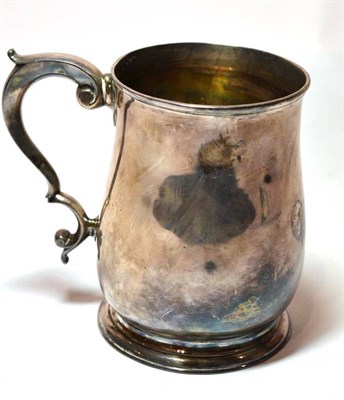 Lot 1330 - A George II Silver Mug, makers mark worn, London 1736, the plain baluster body with scroll...