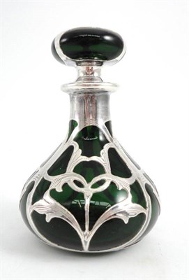 Lot 1371 - An Art Nouveau Green Glass Scent Bottle, with overlaid silver foliate decoration, the base and...