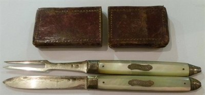 Lot 1408 - A Georgian Folding Knife and Fork, circa 1830, with silver blades and mother of pearl handles...