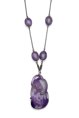 Lot 1000 - An Amethyst Necklace, a carved amethyst drop as a sinuous cat entwined about a boulder,...