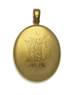 Lot 1009 - An Engraved Locket, the plain polished yellow oval form engraved to one side with entwined initials