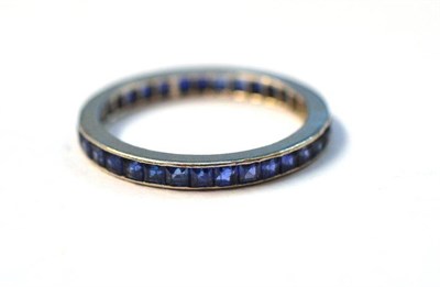 Lot 1016 - A Sapphire Full Eternity Ring, the square cut sapphires channel set within a plain white flat sided