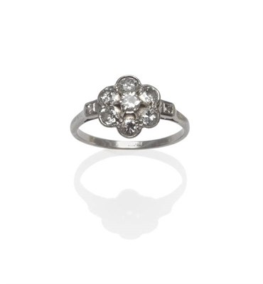Lot 1024 - A Diamond Cluster Ring, seven old cut diamonds in white claw and millegrain settings, to...