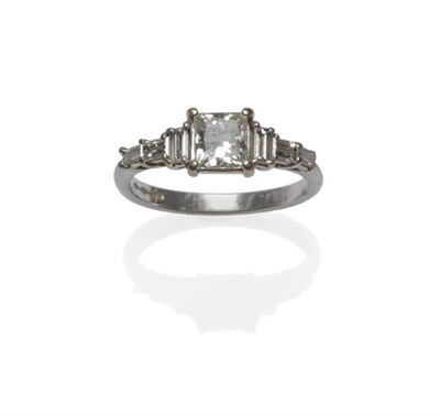 Lot 1026 - A Platinum Diamond Ring, the principal princess cut diamond flanked by three baguette cut...