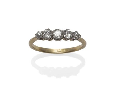 Lot 1027 - A Diamond Five Stone Ring, the graduated old cut diamonds in white claw settings, to a yellow...