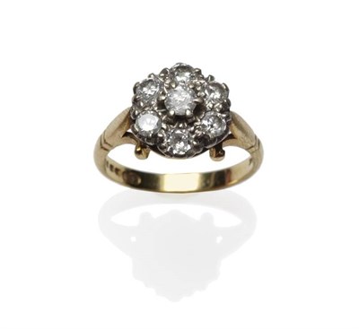 Lot 1043 - An 18 Carat Gold Diamond Cluster Ring, seven round brilliant cut diamonds in white claw...