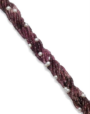 Lot 1044 - A Pink Tourmaline and Freshwater Cultured Pearl Torsade, the shaded faceted beads of pink...