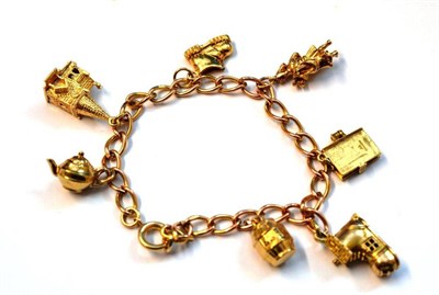 Lot 1053 - A 9 Carat Gold Charm Bracelet, the open links hung with seven charms, mostly hallmarked 9 carat...