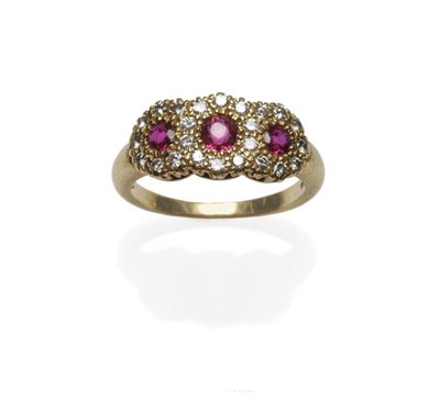 Lot 1065 - An 18 Carat Gold Ruby and Diamond Triple Cluster Ring, three graduated round brilliant cut...