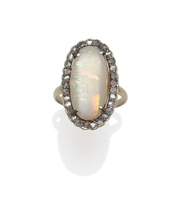 Lot 1084 - An Opal and Diamond Cluster Ring, the polished oval opal within a border of rose cut diamonds,...
