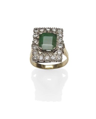 Lot 1085 - An 18 Carat Gold Emerald and Diamond Cluster Ring, the emerald-cut emerald within a border of round