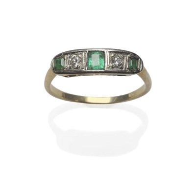 Lot 1097 - An Emerald and Diamond Five Stone Ring, three graduated step cut emeralds alternate with two...