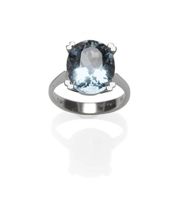 Lot 1112 - An Aquamarine Ring, the oval cut aquamarine in a four claw setting, to a tapered shoulder plain...