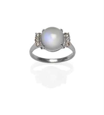 Lot 1113 - A 14 Carat White Gold Moonstone and Diamond Ring, the cabochon moonstone flanked by a trio of round