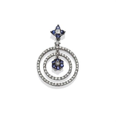 Lot 1114 - A Sapphire and Diamond Pendant, a floral cluster of diamond and sapphire suspends two hoops, with a