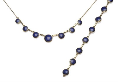 Lot 1131 - A Lapis Lazuli Necklace and Bracelet, round polished lapis lazuli stones in yellow bezel...