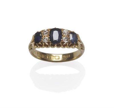 Lot 1133 - An 18 Carat Gold Sapphire and Diamond Ring, three graduated oval cut sapphires alternate with pairs