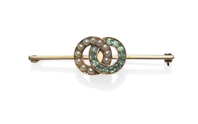 Lot 1143 - An Emerald and Pearl Brooch, circa 1910, two entwined hoops, one set with split pearls, the...