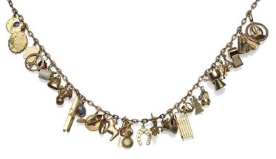 Lot 1179 - A Charm Necklace, the trace link chain hung with thirty charms, including skis, a windmill, a...