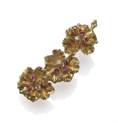 Lot 1183 - An 18 Carat Gold Ruby and Diamond Set Brooch, in the form of three conjoined flowers on a stem,...