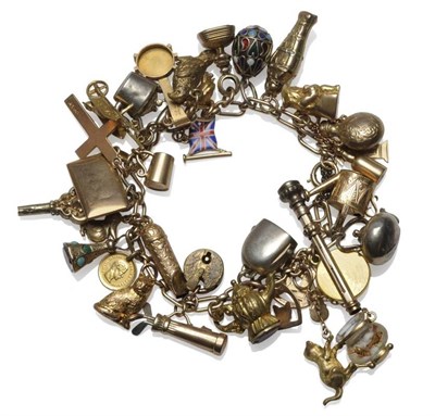 Lot 1188 - A Charm Bracelet, trace links hung with thirty-four charms, including a cat with a gold fish...