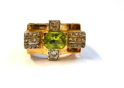 Lot 1196 - A Peridot and Diamond Ring, the fancy octagonal cut peridot centrally, to a border set with...