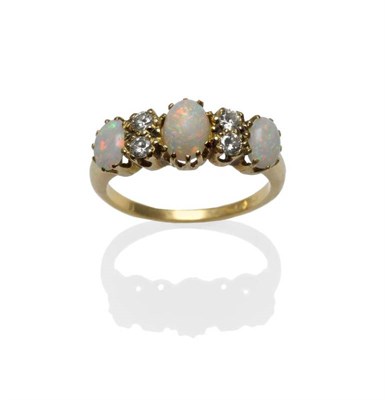 Lot 1207 - An Opal and Diamond Ring, three graduated cabochon opals alternate with pairs of round...