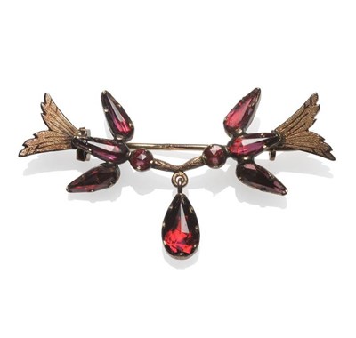 Lot 1211 - A Bird Brooch, two birds form the bar, the bodies set throughout with foil backed garnets,...