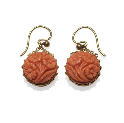 Lot 1212 - A Pair of Coral Drop Earrings, round coral carved with floral depictions, in a yellow claw setting