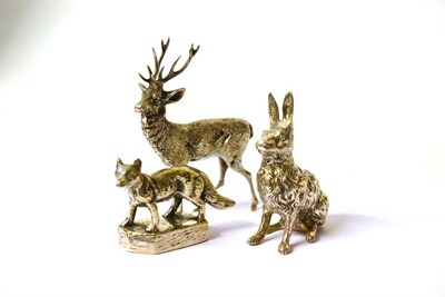 Lot 1293 - Three Unmarked Silvered Metal Models of Animals , each naturalistically modelled as a fox on a...