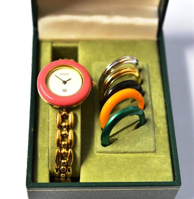 Lot 1009 - A Lady's Wristwatch with interchanging bezels, signed Gucci, circa 1990, quartz movement, white...