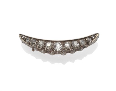 Lot 1024 - A Diamond Crescent Brooch, the crescent set with graduated old cut and rose cut diamonds, with tiny