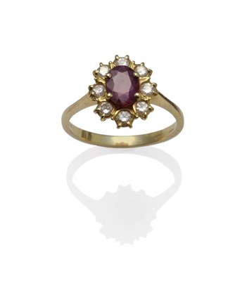 Lot 1037 - An 18 Carat Gold Ruby and Diamond Cluster Ring, an oval cut ruby within eight round brilliant...