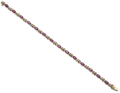 Lot 1042 - A Ruby and Diamond Bracelet, each oval cut ruby sits between two round brilliant cut diamonds,...