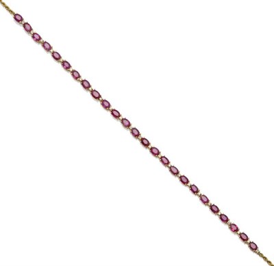 Lot 1043 - An 18 Carat Gold Ruby and Diamond Set Necklace, the oval cut rubies alternated with small round...